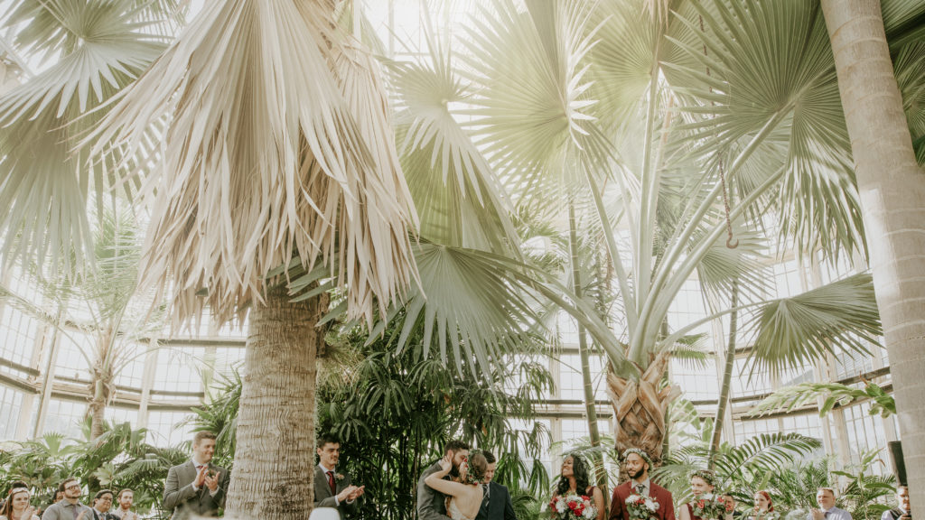 the bride and grooms first kiss at rawlings conservatory.